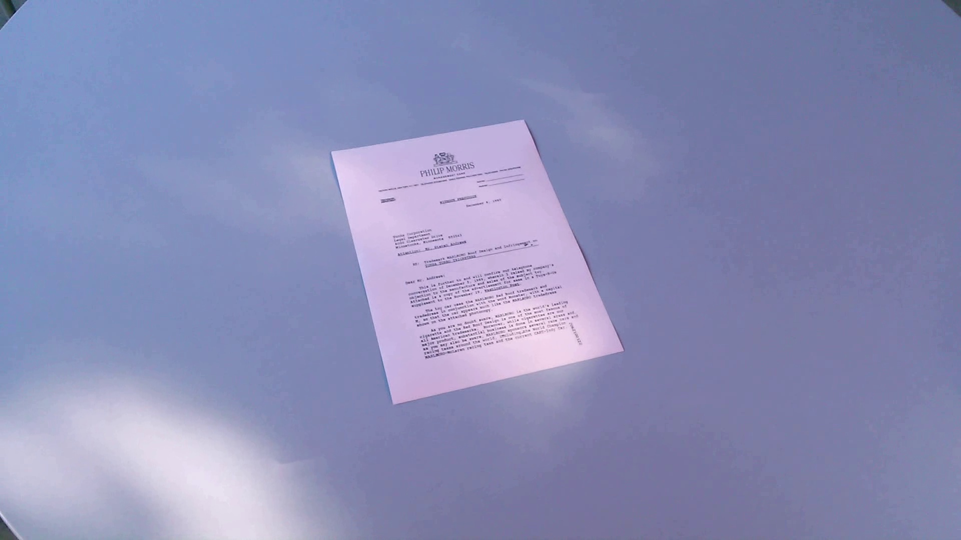 Phone photo of a letter with uneven light and desk shadow